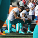 Kenny Stills #10 and Albert Wilson #15 of the Miami Dolphins kneel during the national anthem prior to their game against the New England Patriots at Gillette Stadium on September 30, 2018 in Foxborough, Massachusetts.